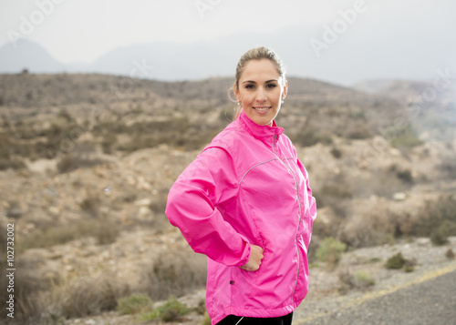 young attractive sport woman in running jacket posing with attitude defiant cool