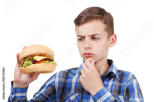 Boy eating a hamburger. isolated on white