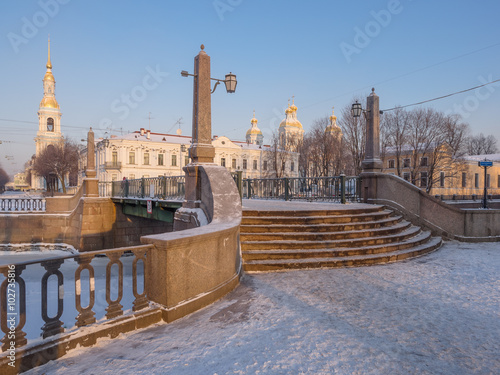 St. Petersburg winter morning. Krasnogvardejskij bridge at the intersection of Griboyedov Canal and the Kryukov Canal, view of the dome and bell tower of St. Nicholas Naval Cathedral photo