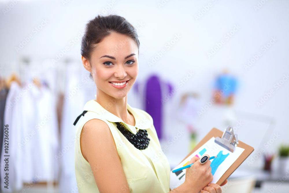 Modern young fashion designer working at studio. Modern young fashion designer working at studio.