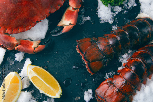 Crab and lobster tails on blackboard
