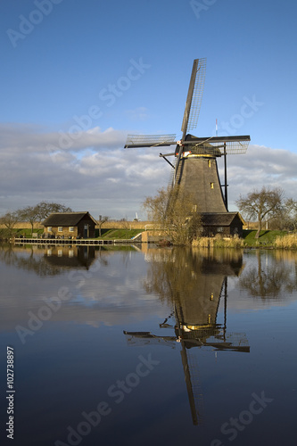 Row of Dutch windmills mirrored in water, Unesco World Heritage Kinderdijk, South Holland, Netherlands