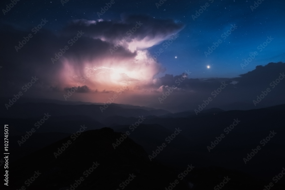 Carpathian Mountains. Mount Pop Ivan. Thunderhead and the starry sky above the ridge Montenegrin