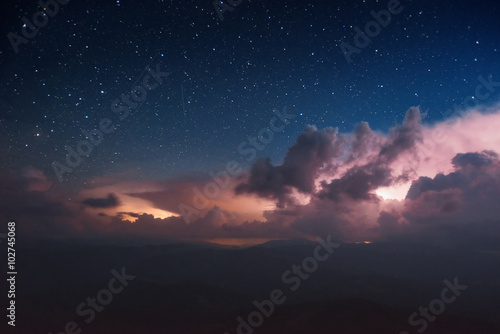 Carpathian Mountains. Mount Pop Ivan. Thunderhead and the starry sky above the ridge Montenegrin
