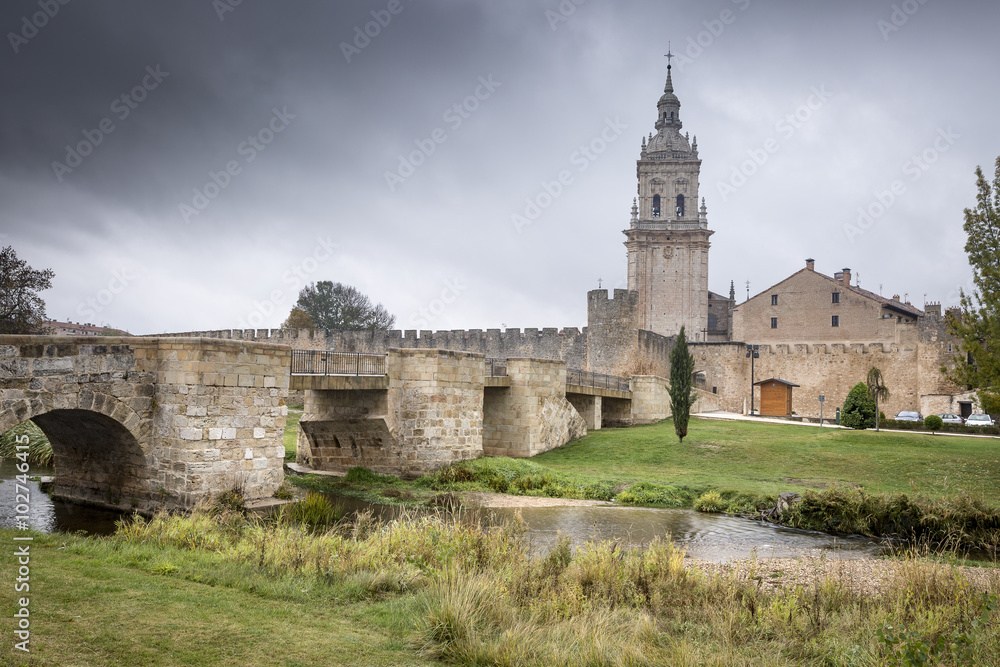 ancient bridge, city wall and cathedral, Burgo de Osma on a rainy day, Soria, Spain