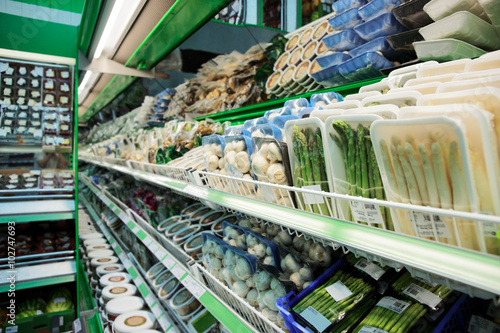 Shelf with groceries in supermarket photo