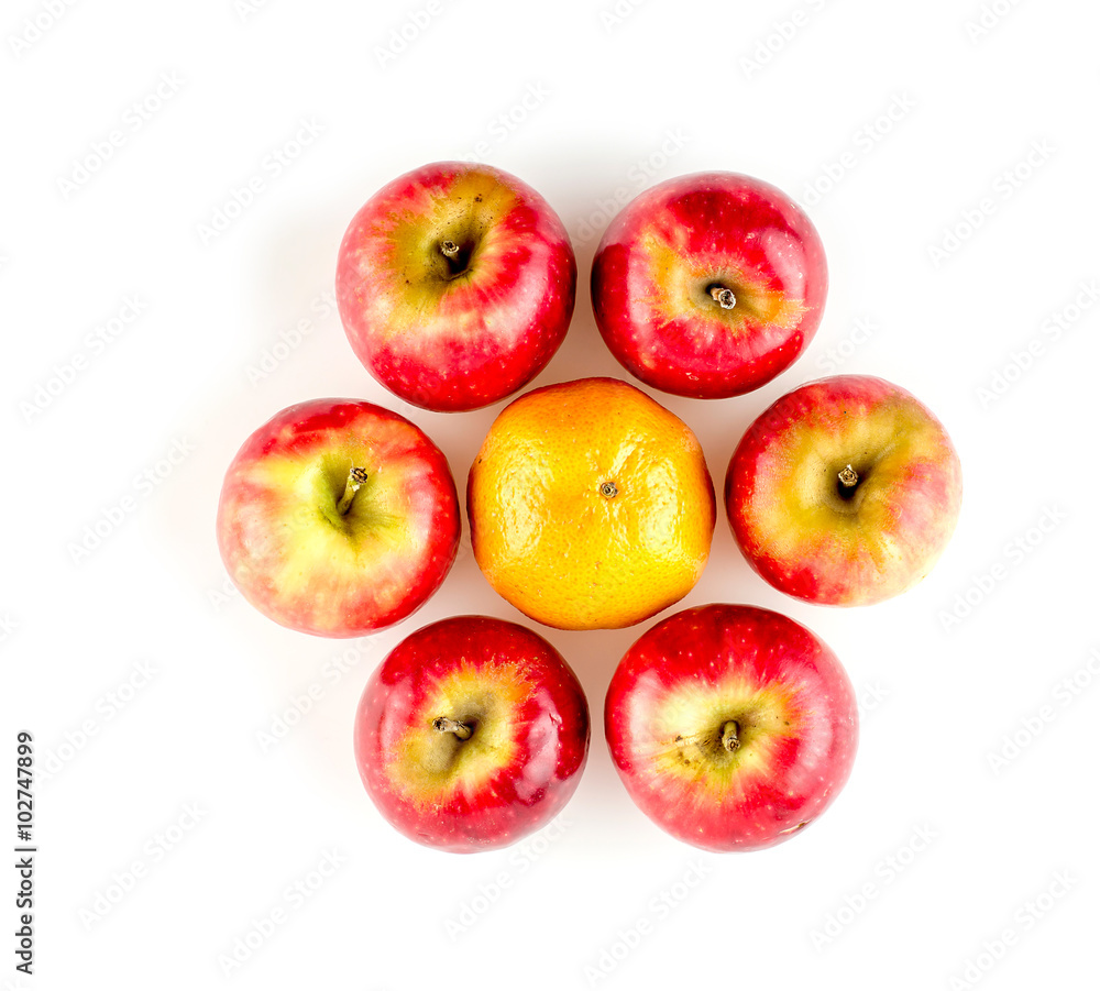 Apples surrounding one orange arranged in circular flower shape Apples surrounding one orange arranged in circular flower shape