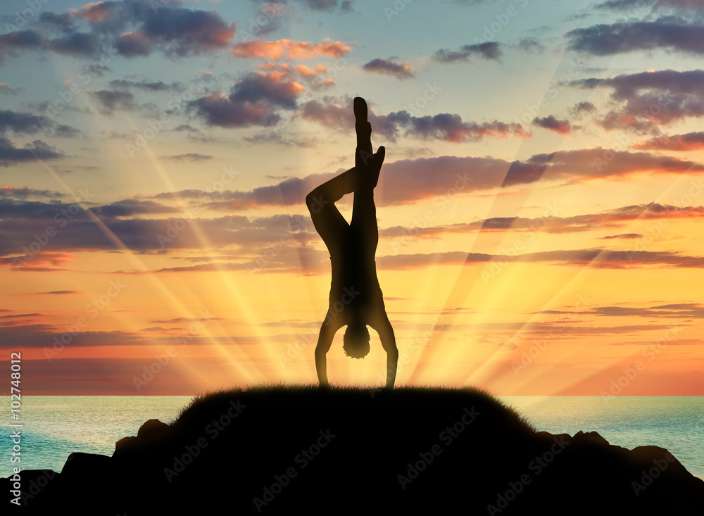 Silhouette of a man practicing yoga