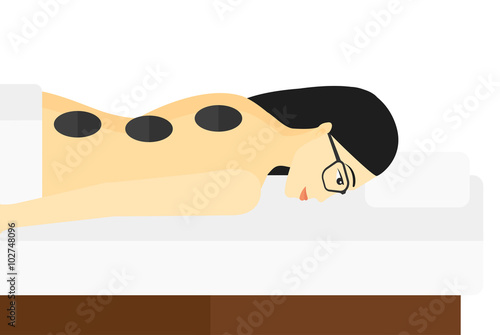 Woman getting stone therapy.