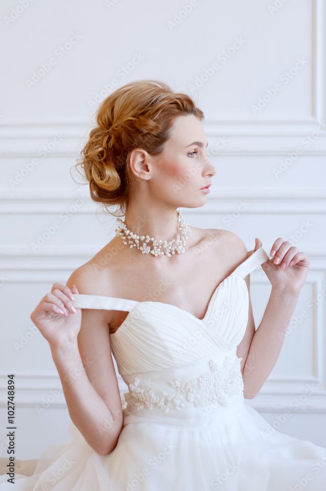Young adult caucasian blond bride in white gown Young adult caucasian blond bride in white gown