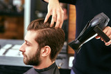 drying, styling men's hair in a beauty salon