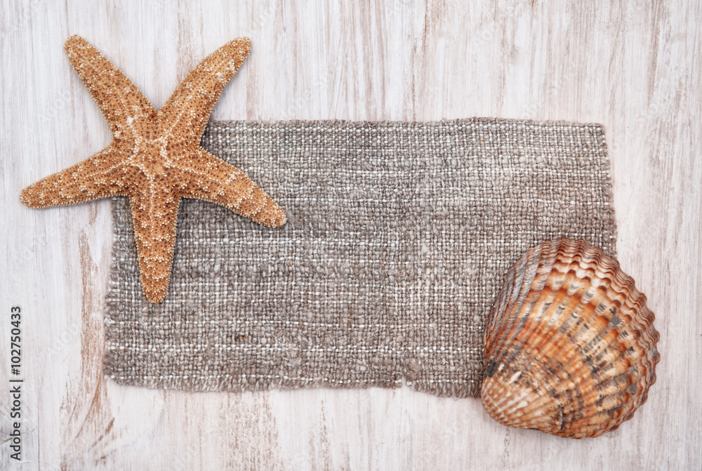 Shabby chic background with seashells and sackcloth Shabby chic background with seashells and sackcloth