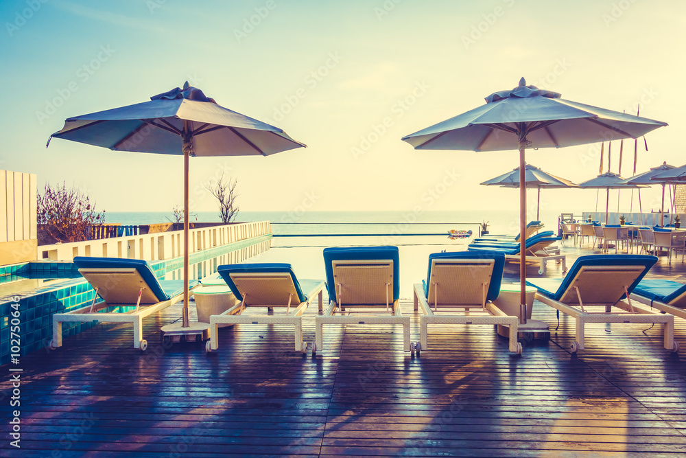 Fototapeta premium Umbrella and chair around swimming pool