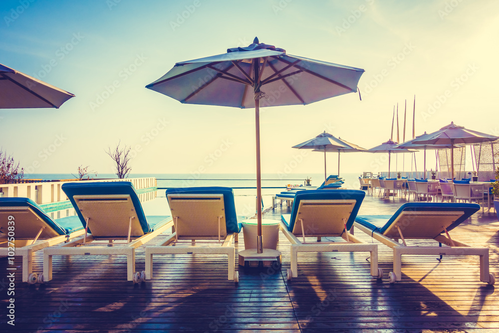 Fototapeta premium Umbrella and chair around swimming pool