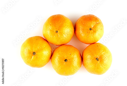 Five juicy whole oranges isolated on white