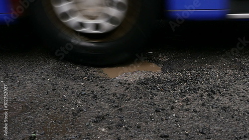 Wallpaper Mural Pothole on the street, cracked asphalt - slow motion Torontodigital.ca