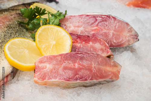 Fresh trout fish and fillet with lemons