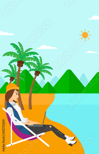 Business woman sitting in chaise lounge with laptop.