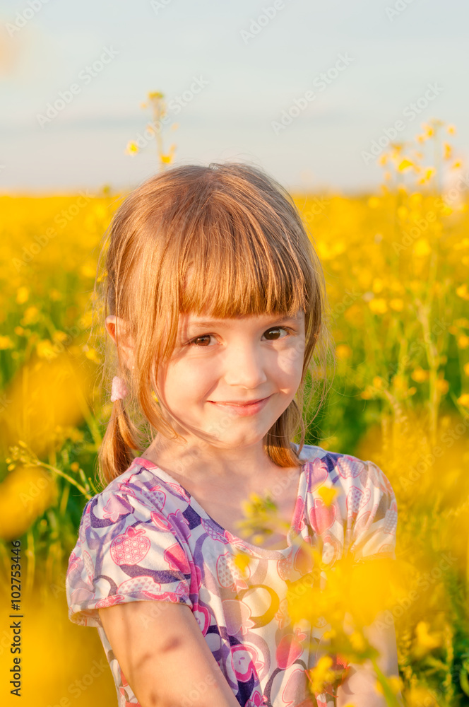 Girl with pigtails in a field of yellow flowers Girl with pigtails in a field of yellow flowers