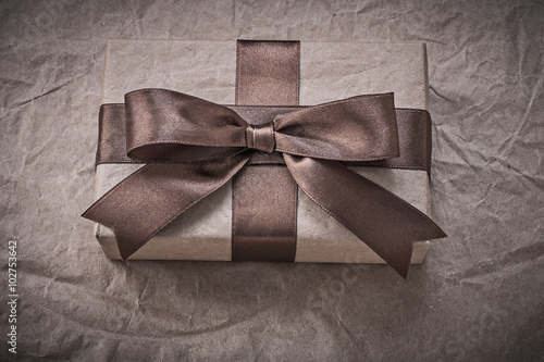 Giftbox with present tape on wrapping paper holidays concept