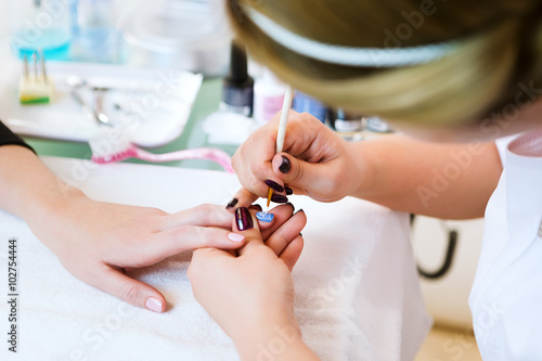 Applying nail polish on nails