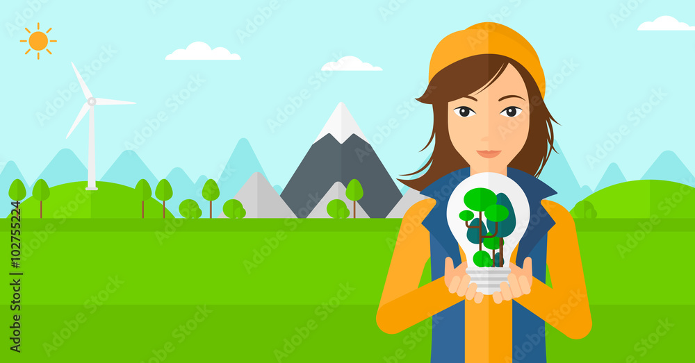 Woman with lightbulb and trees inside.