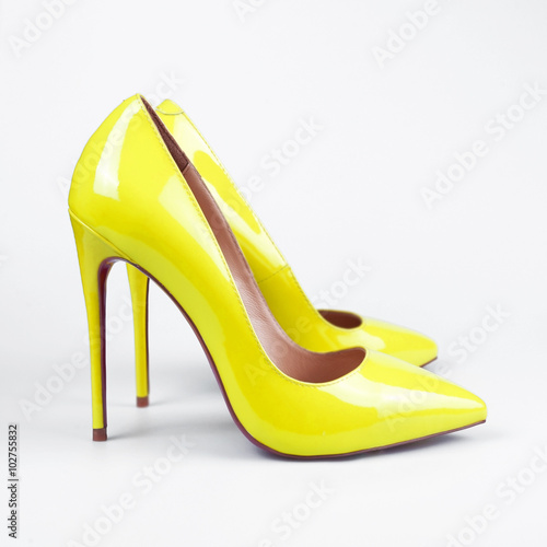 Pair of yellow modern fashionable women shoes shot in studio
