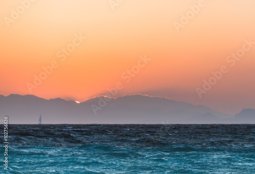 Yacht at sunset in the Aegean Sea. Rhodes Island. Greece