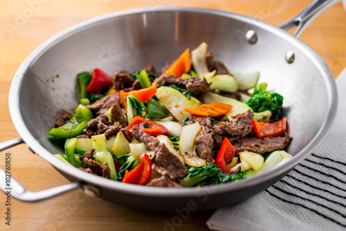Healthy vegetable & beef stir-fry. Made with flank steak, peppers, onions and bok choy stir fried in an asian wok.