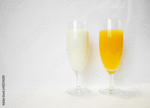 milk and orange in wineglass