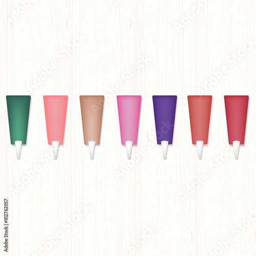 Set of realistic colored cream shadows on white wooden table