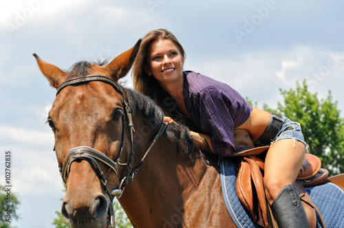 young attractive woman horseback riding