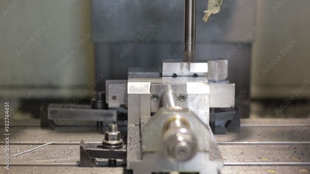 Close-up CNC machine milling some steel part Close-up CNC machine milling some steel part