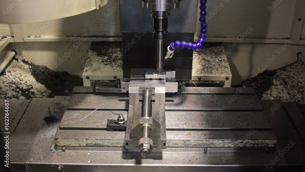 Close-up CNC machine milling some steel part Close-up CNC machine milling some steel part