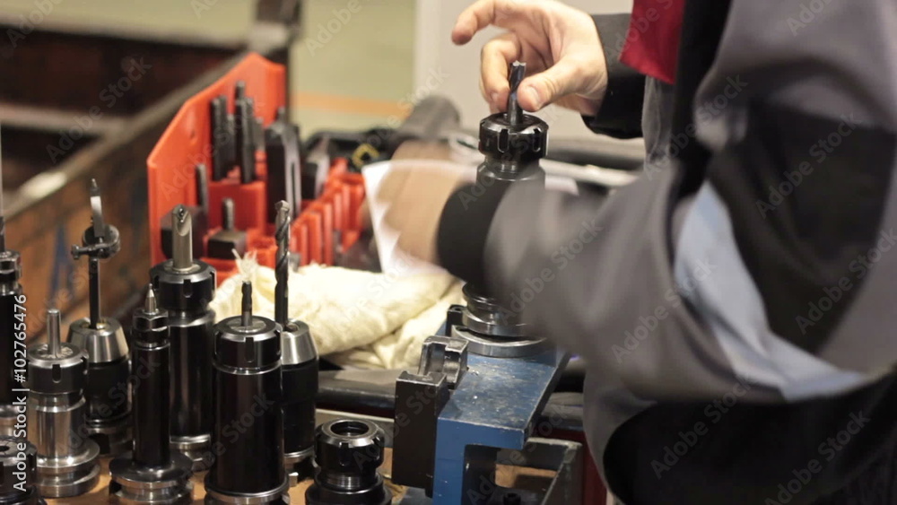 Close-up mechanical industrial worker measuring detail in tool workshop. Close-up mechanical industrial worker measuring detail in tool workshop.