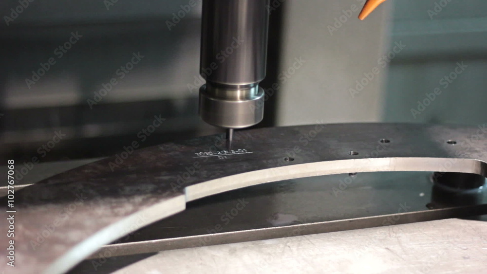 CNC machine engraving numbers on steel part. Close-up CNC machine engraving numbers on steel part. Close-up
