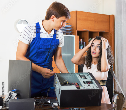 Portrait of stressed woman and PC spesialist photo