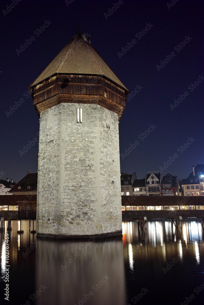 Night photo of tower of Chapel Bridge in City of Lucern, Canton of Lucerne, Switzerland
