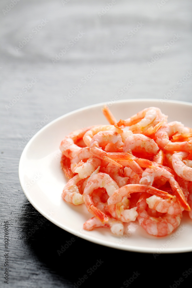 Fresh boiled shrimps on a black wooden table Fresh boiled shrimps on a black wooden table