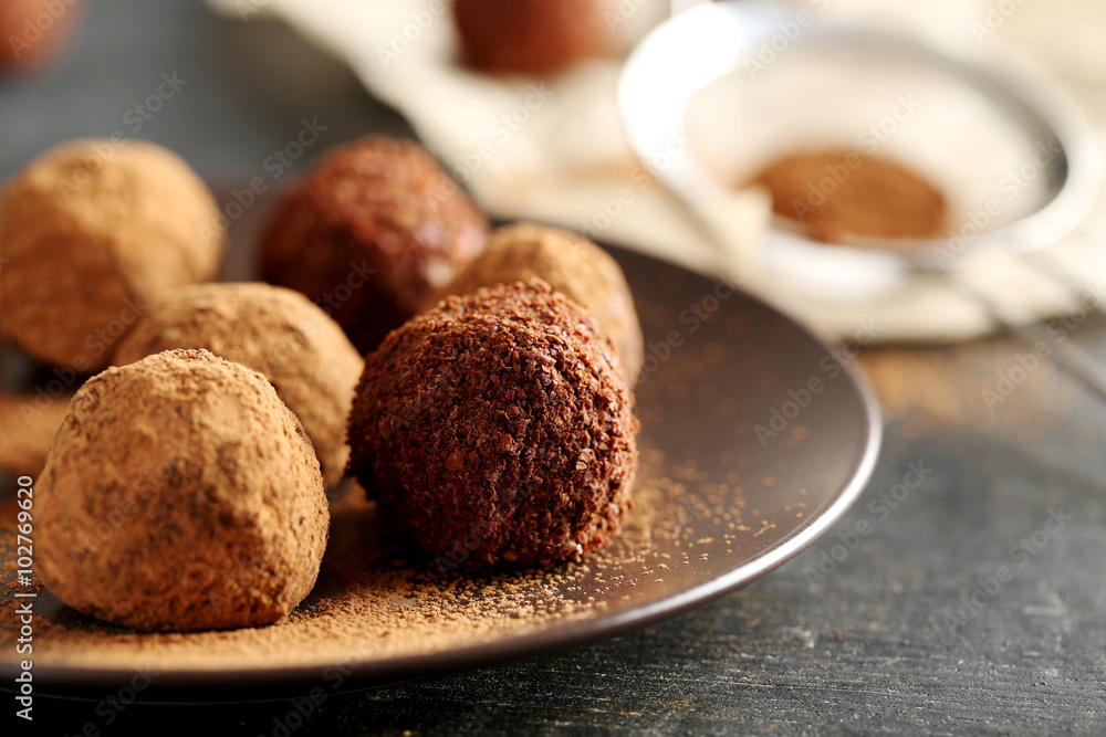 Sweet chocolate truffle on a black wooden table Sweet chocolate truffle on a black wooden table
