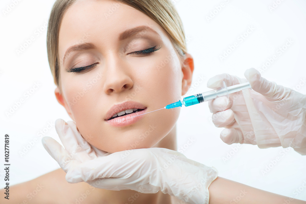Professional cosmetologist making injections 