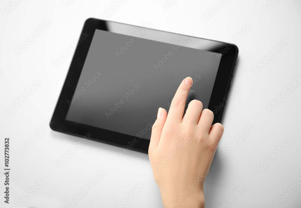 Female hand using modern tablet, isolated on white Female hand using modern tablet, isolated on white