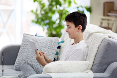 Little boy using tablet on ...