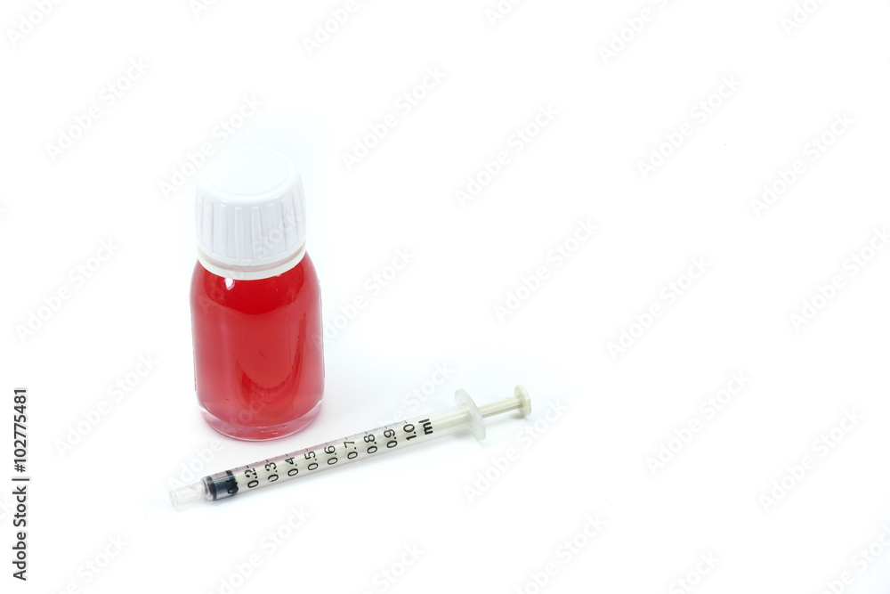 Medical syringe with a bottle of red liquid medicines, drugs, isolated