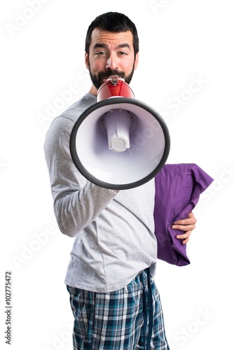Man in pajamas shouting by megaphone