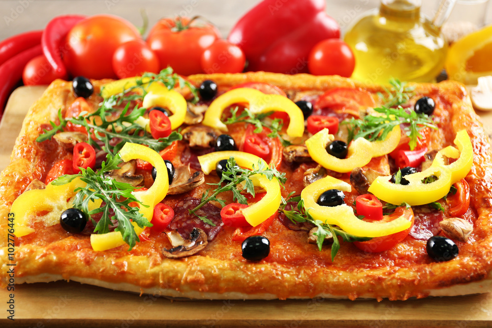 Rectangle delicious pizza and vegetables on the table Rectangle delicious pizza and vegetables on the table
