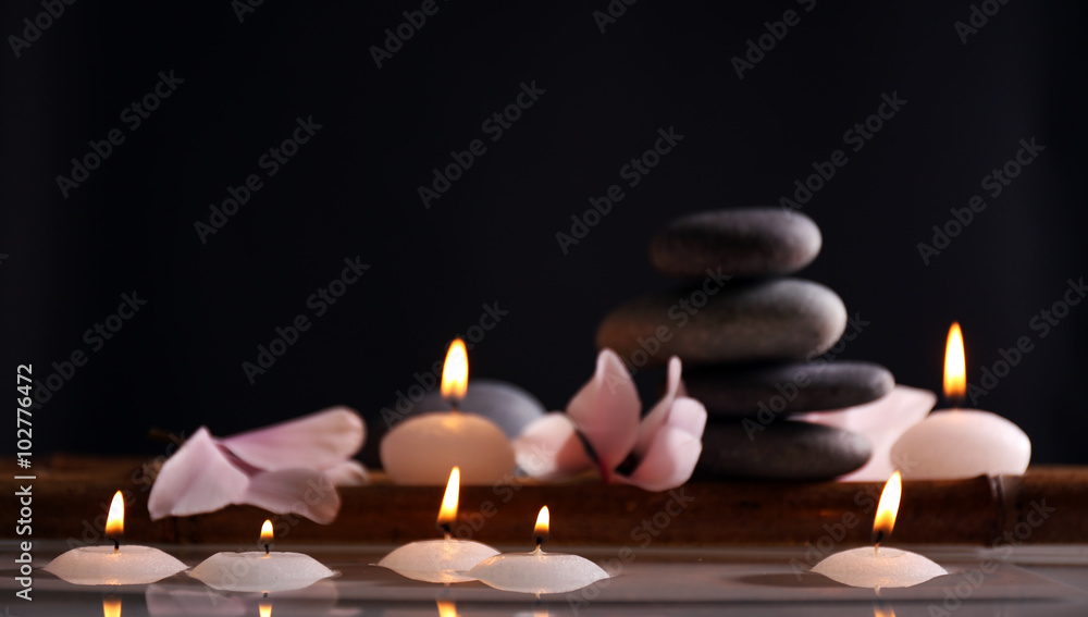 Spa still life with candles in water on dark background Spa still life with candles in water on dark background