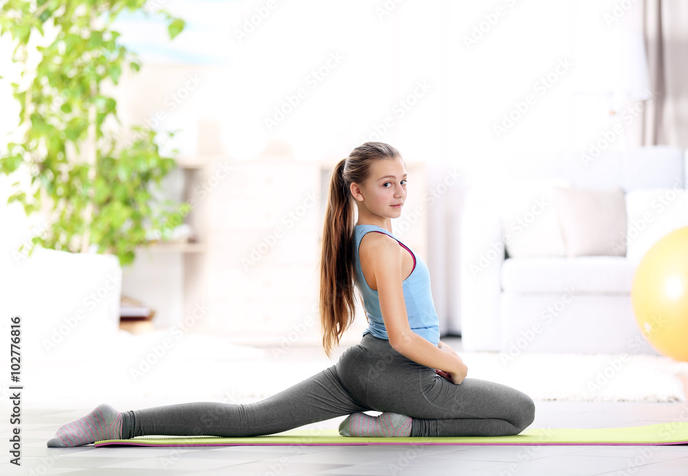 Young girl making fitness exercise indoors Young girl making fitness exercise indoors