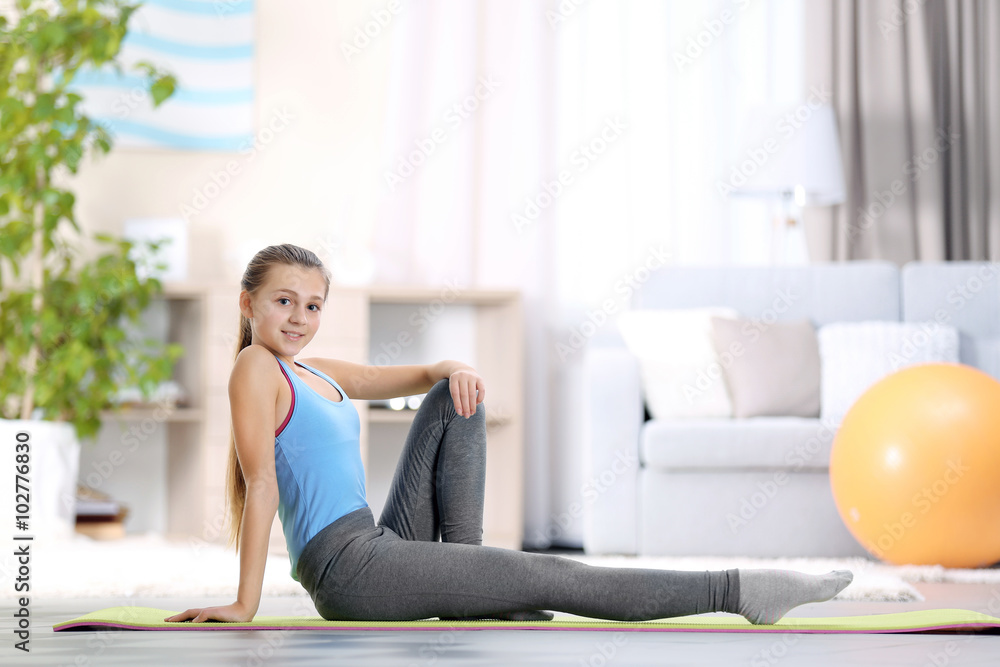 Young girl making fitness exercise indoors