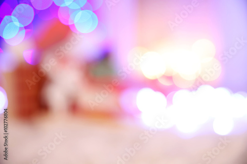 Blurred background of Christmas gift boxes and decoration on the soft carpet